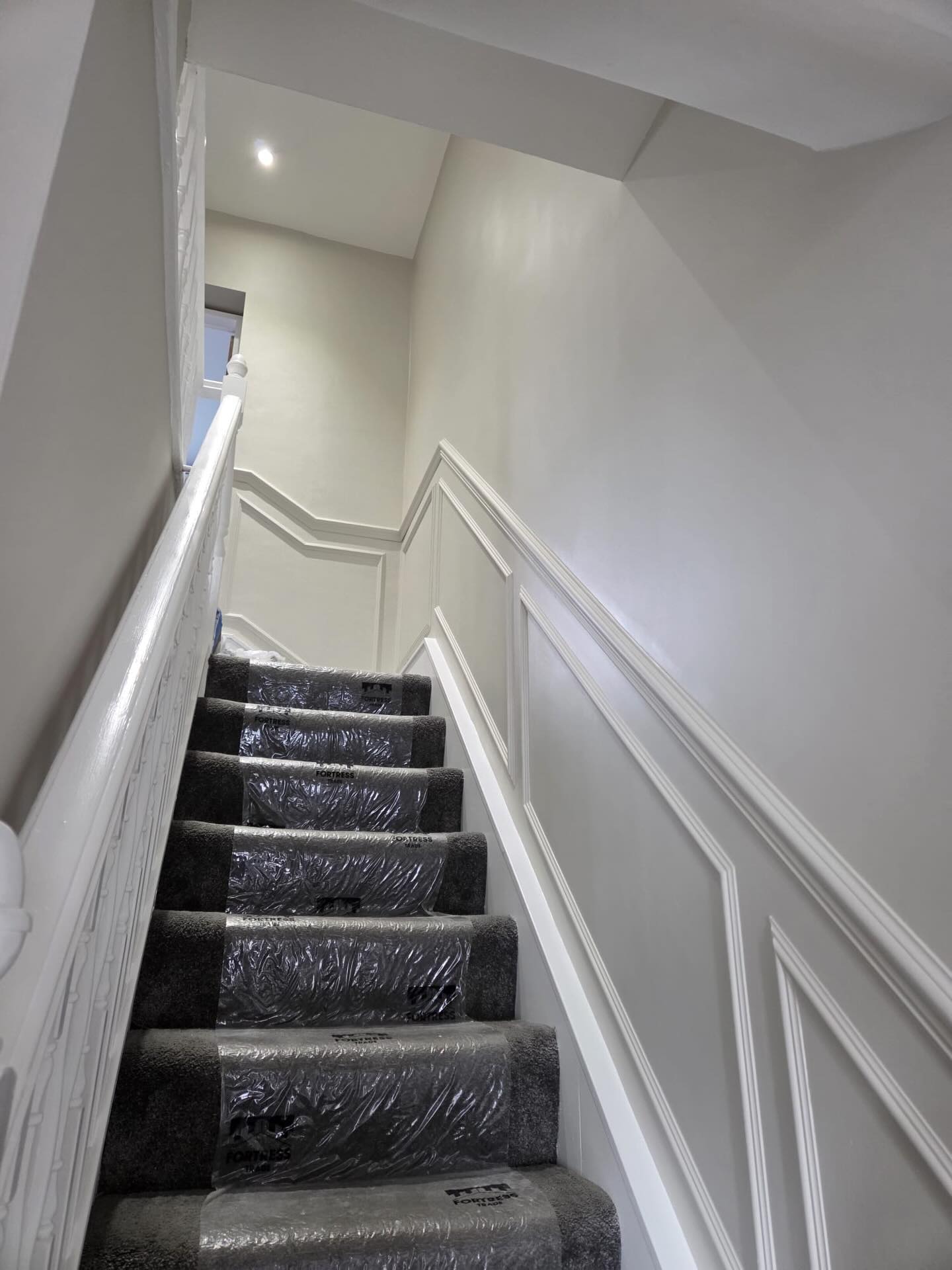 Painted wall panelling following the staircase